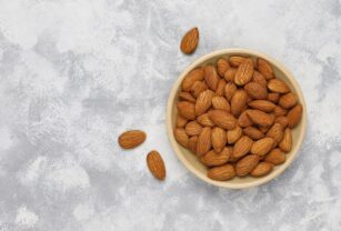 Fresh almonds in ceramic plates.top view