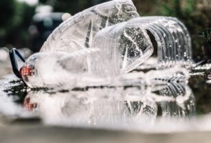 close up of plastic solid waste floating on the water